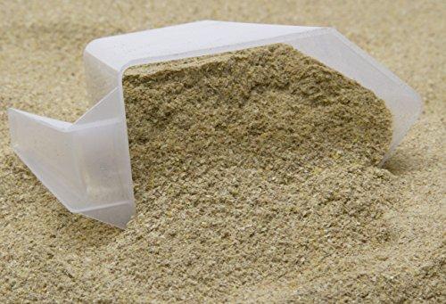 Close-up of Urban Worm Chow premium protein-rich worm food in a scoop for feeding composting worms, worm farms, and vermicomposting bins.