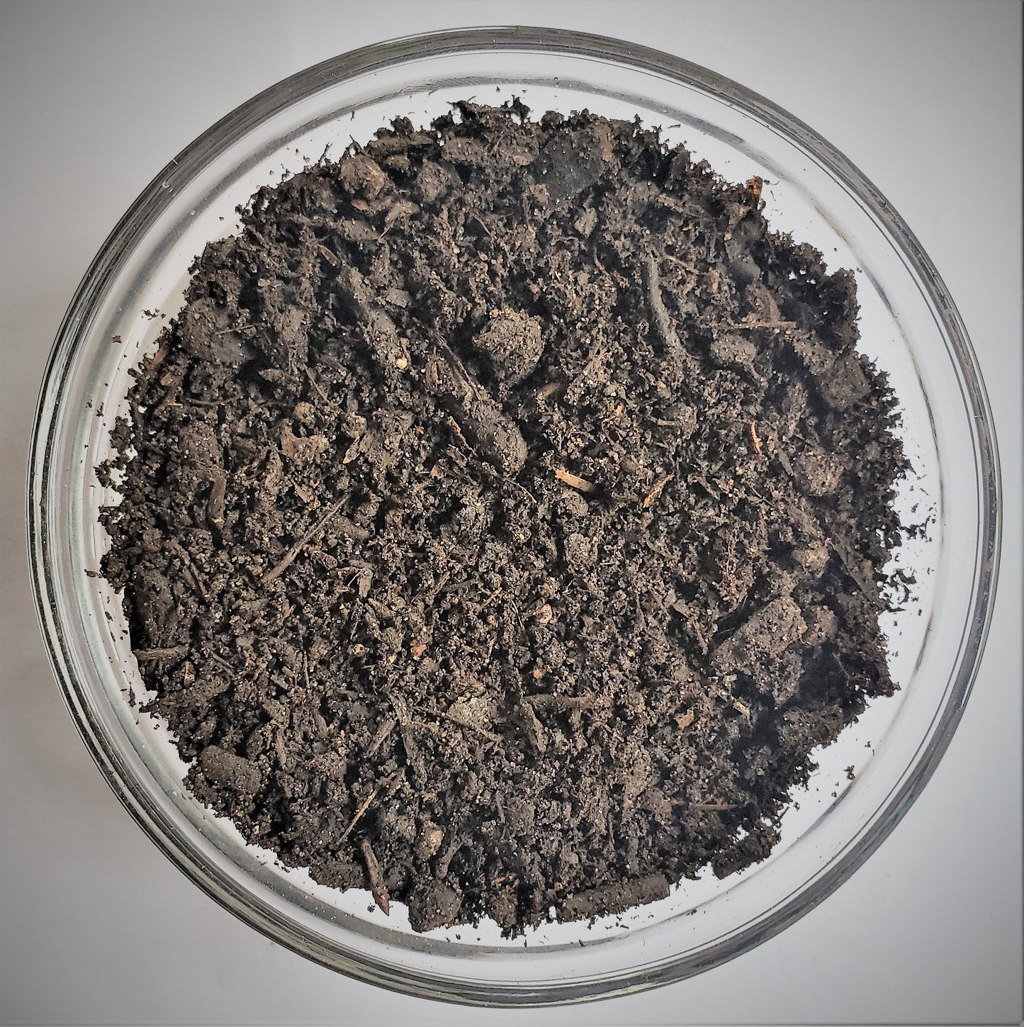 Close-up of The Soil Makers Elite Compost, a premium 100% organic compost made from composted organic materials to improve soil structure, support beneficial microorganisms, and promote healthy plant growth in raised beds, containers, and vegetable gardens.
