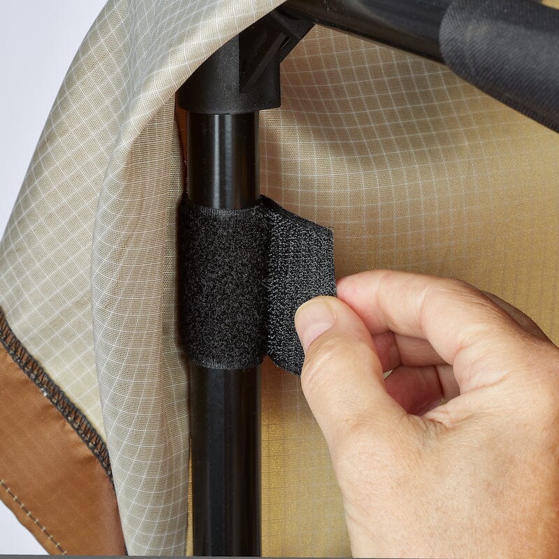 Close-up of the Urban Worm Bag Weather Cover hook-and-loop fastening strap securing the cover to the worm bin frame for a stable outdoor fit.