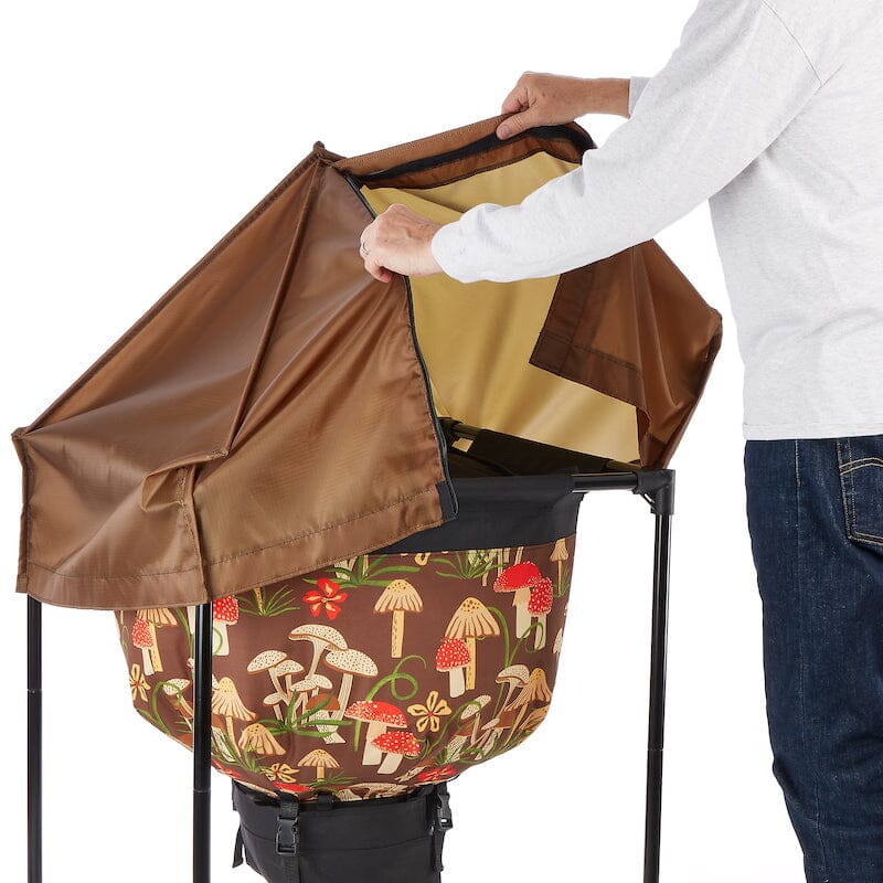 Person opening the Urban Worm Bag Weather Cover for easy access to the worm composting bin while maintaining outdoor weather protection.